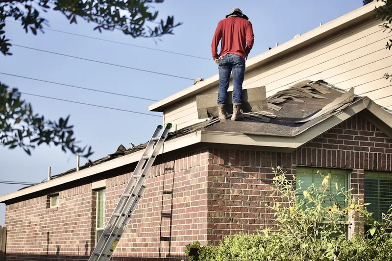 Professional roofer working on a residential roof in Elkton